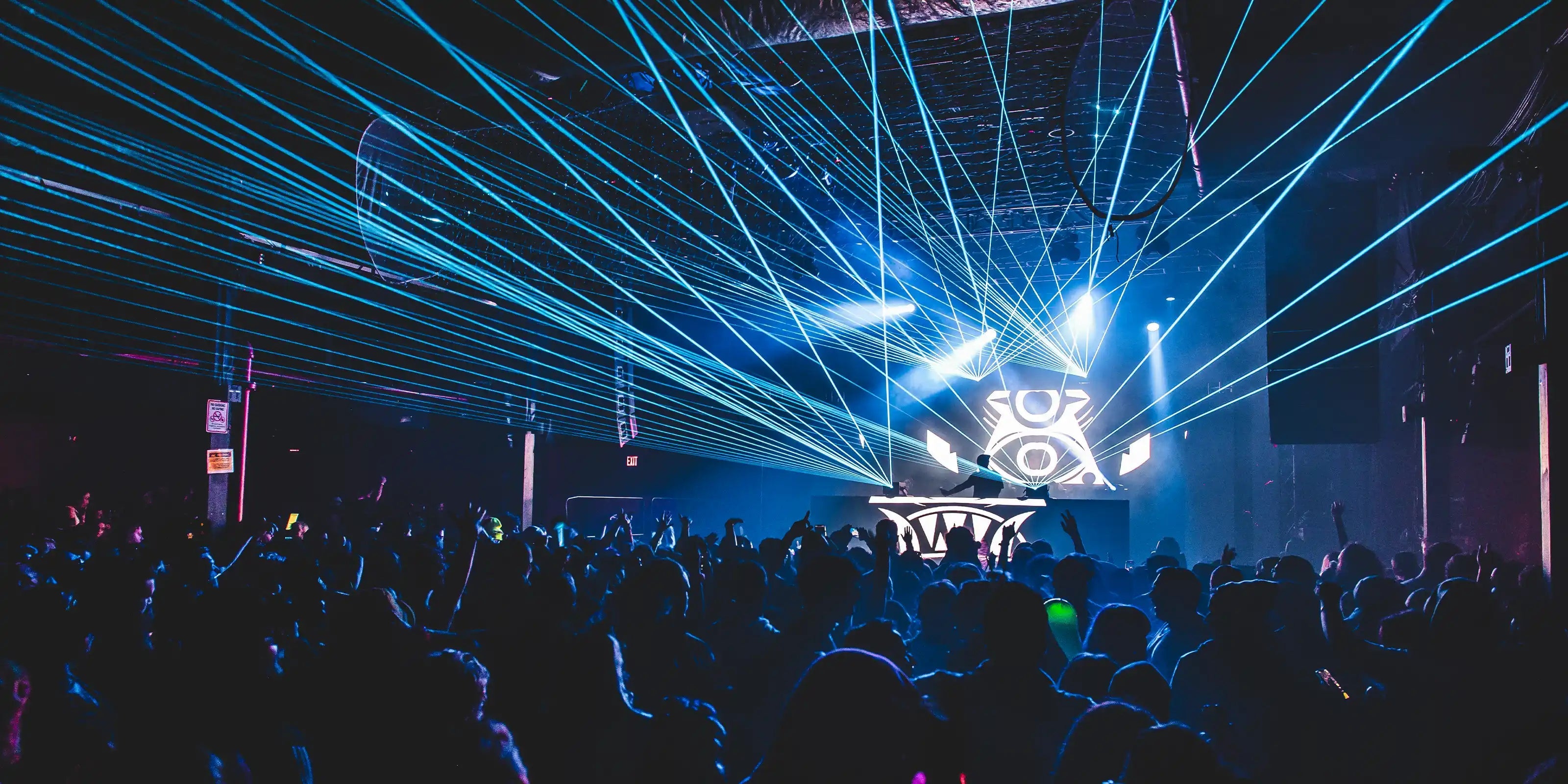 Dance floor with laser lights and a crowd at a music event